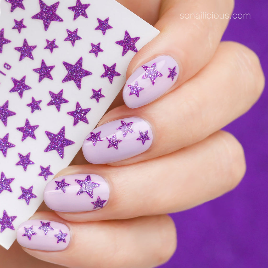 purple nails with glitter star stickers