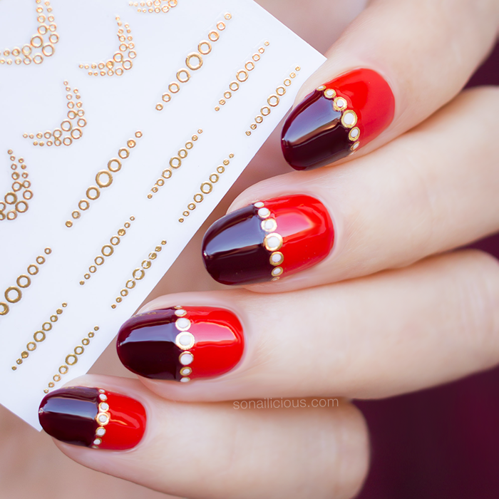 gold and red nails with gold nail stickers