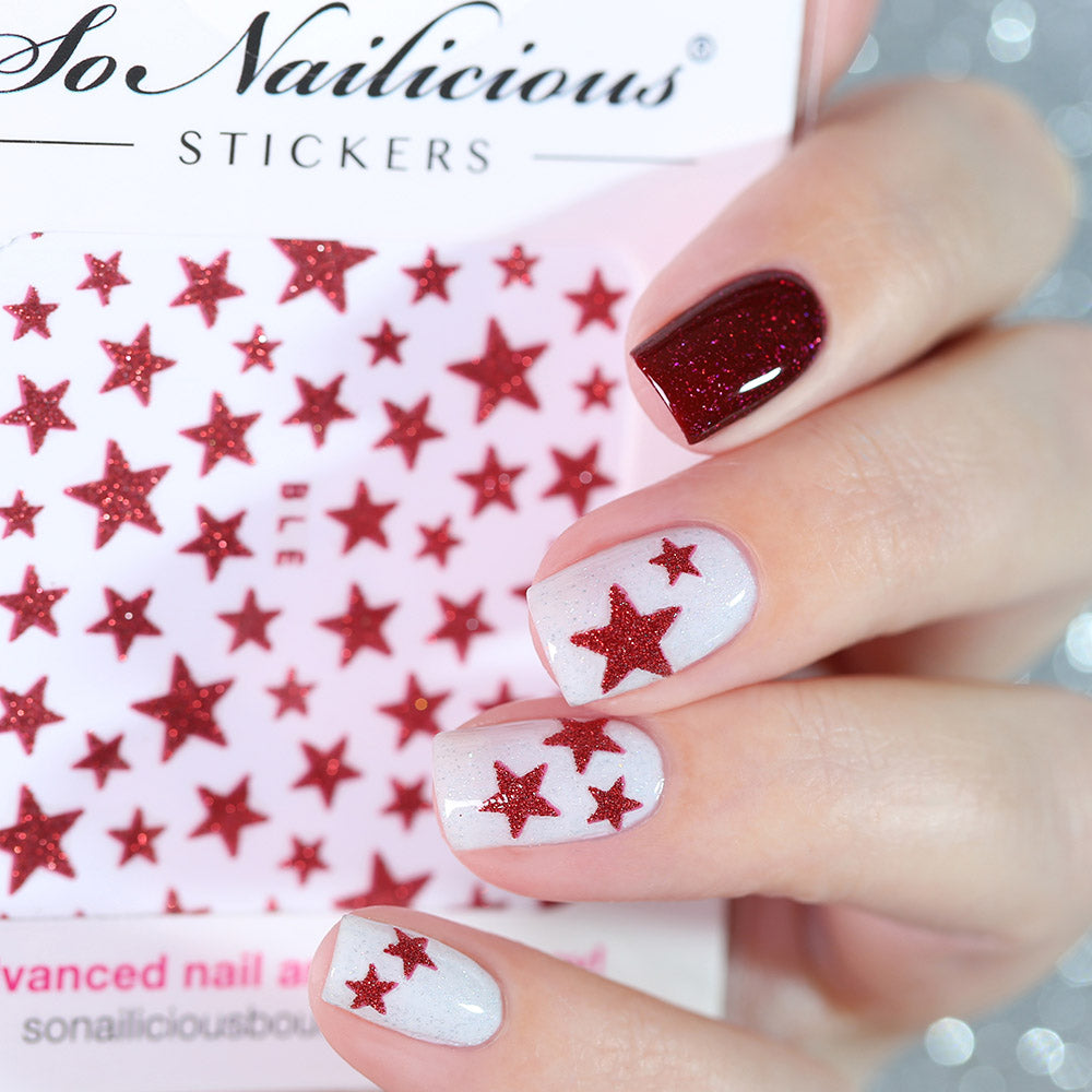 White nails with red glitter star stickers