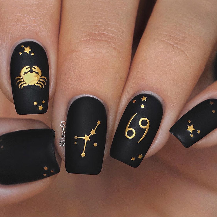 Black and gold nails with Zodiac nail stickers