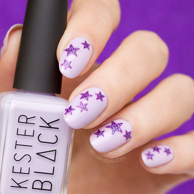 Purple nail art with star stickers