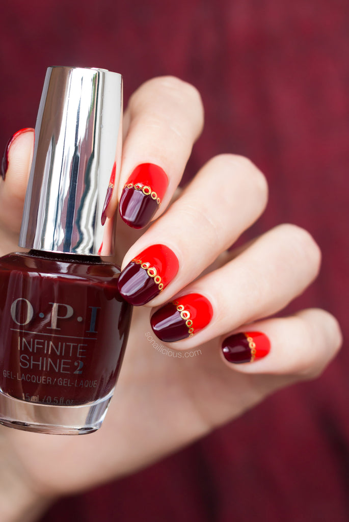 Red nails with gold nail stickers