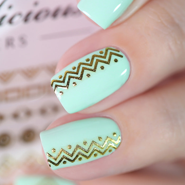 mint nails with golden goddess stickers