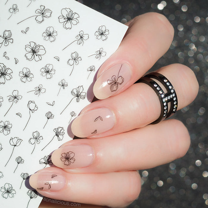nude nails with black flower tatto stickers